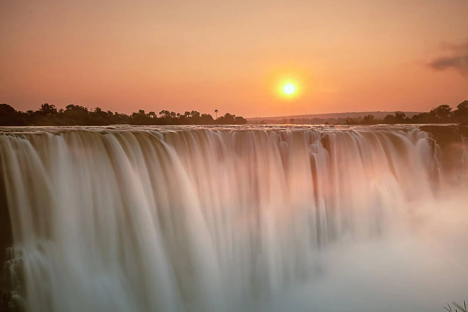 zimbabwe Victoria Falls aerial - the full curtain, gorge, spray rising, helicopter shot
